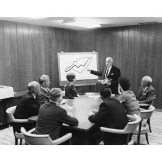 Businessman giving a presentation in a conference room Poster Print (18 x 24)